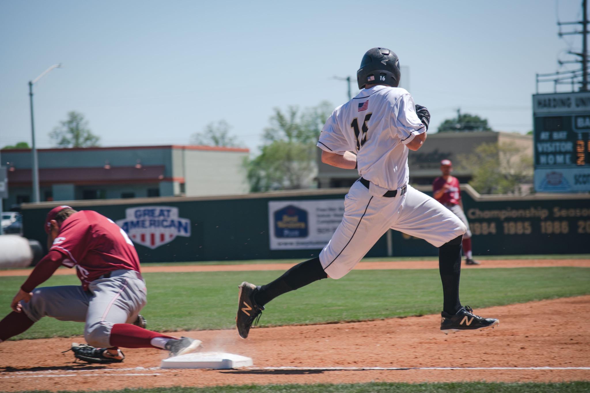 Baseball player running toward first base during a game
