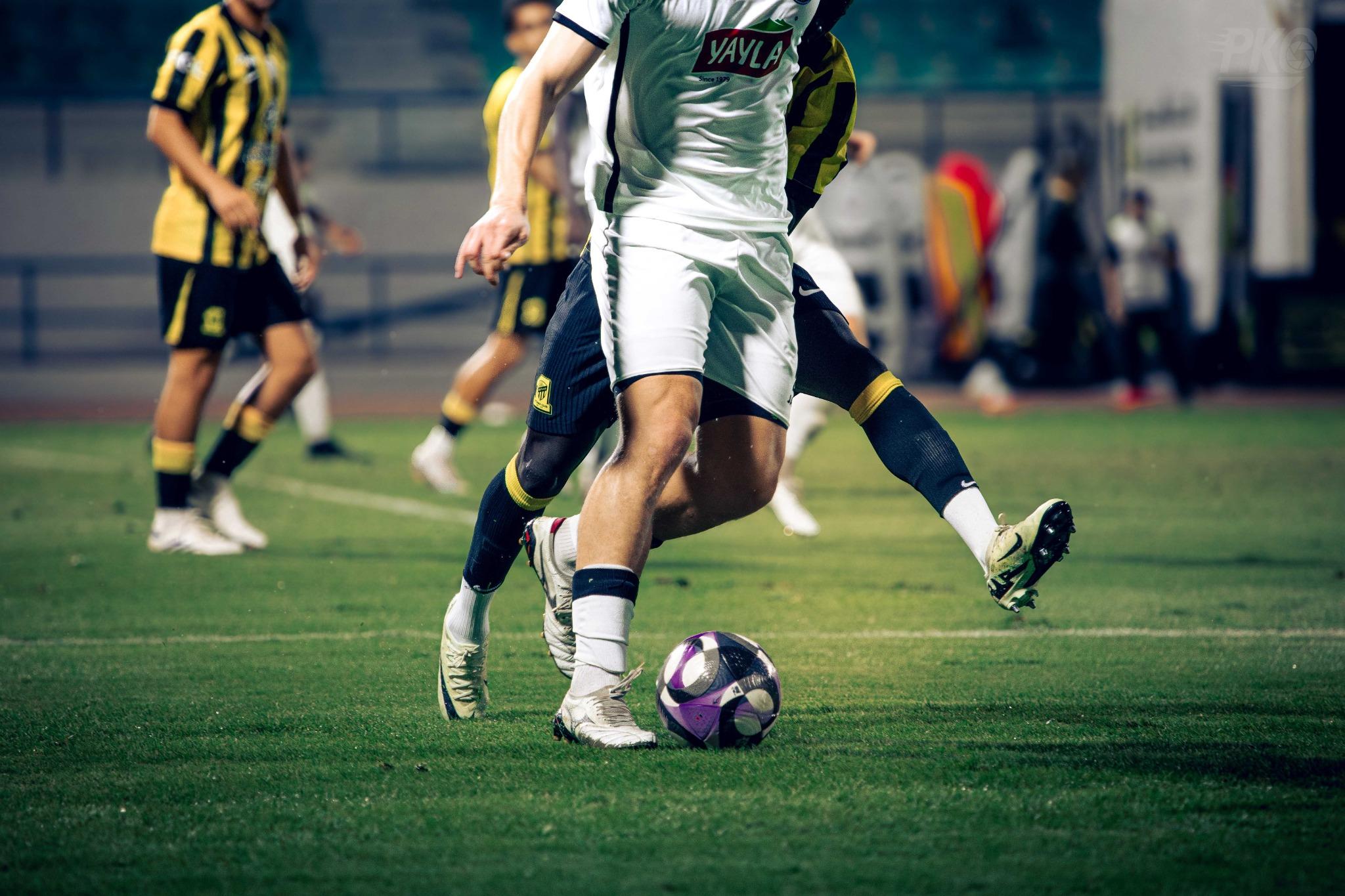 Soccer players contesting the ball during a match
